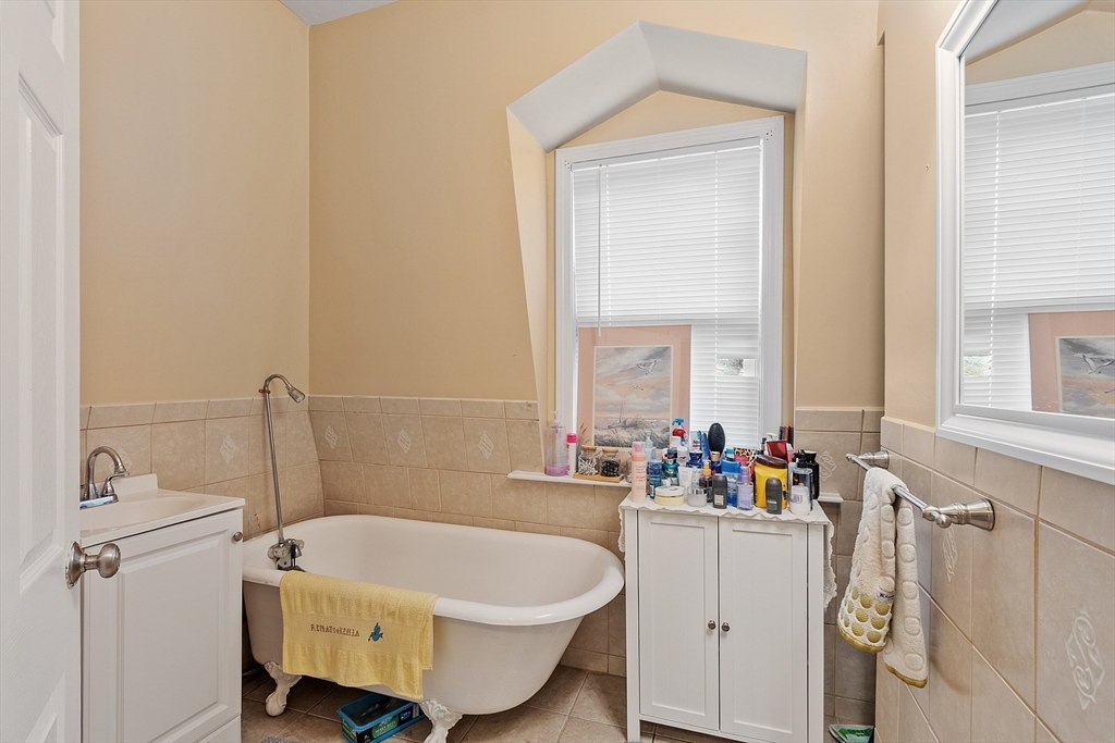 7 Washington Street Somerville, MA 02143 - Photo 20 of 27 a bathroom with a sink mirror toilet and window