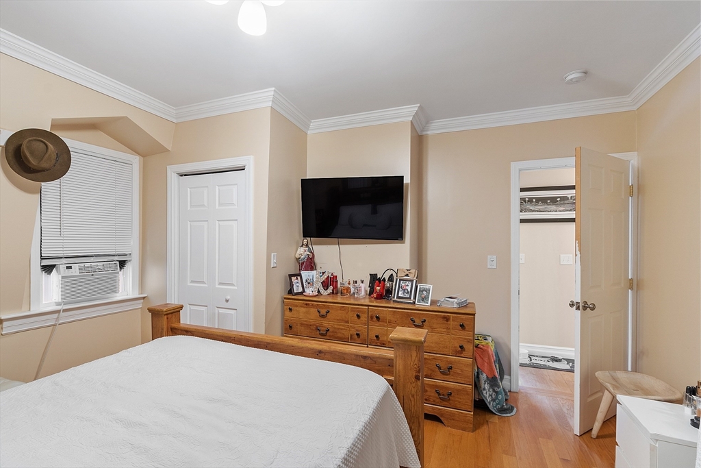 7 Washington Street Somerville, MA 02143 - Photo 24 of 27 a bedroom with a bed and a flat screen tv