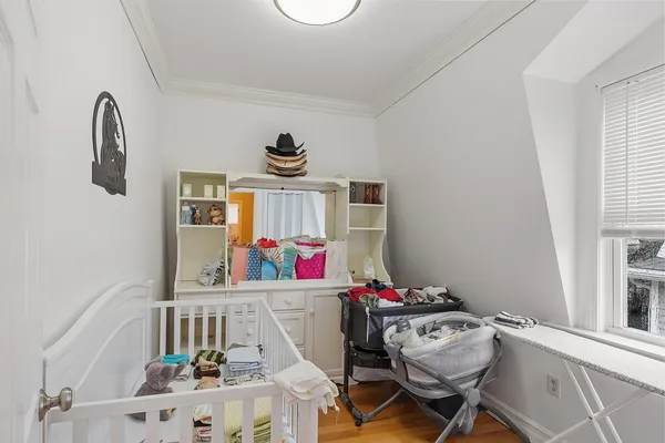 a view of a hallway with furniture and a window
