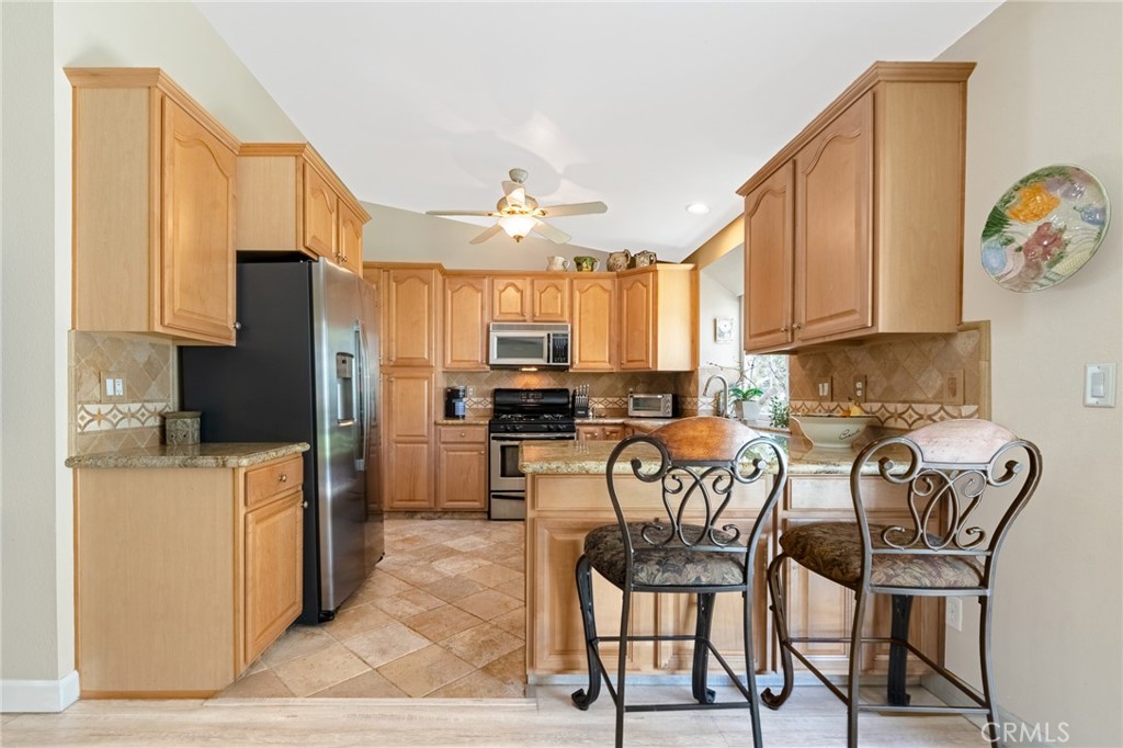 10554 Champagne Road Rancho Cucamonga, CA 91737 - Photo 14 of 25 Family Room is Open to Kitchen with Breakfast Bar