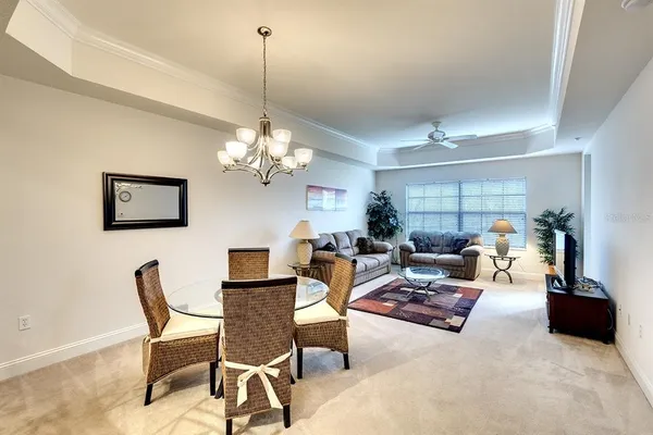 a view of a dining room with furniture and chandelier