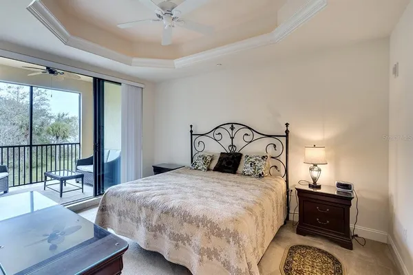 a bedroom with a bed and a dresser with mirror