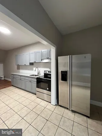 a kitchen with stainless steel appliances a refrigerator sink and cabinets