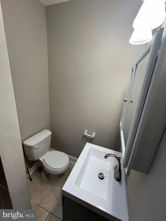 a white toilet sitting next to a white sink