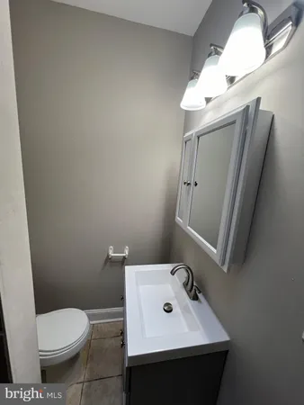 a bathroom with a sink toilet and mirror