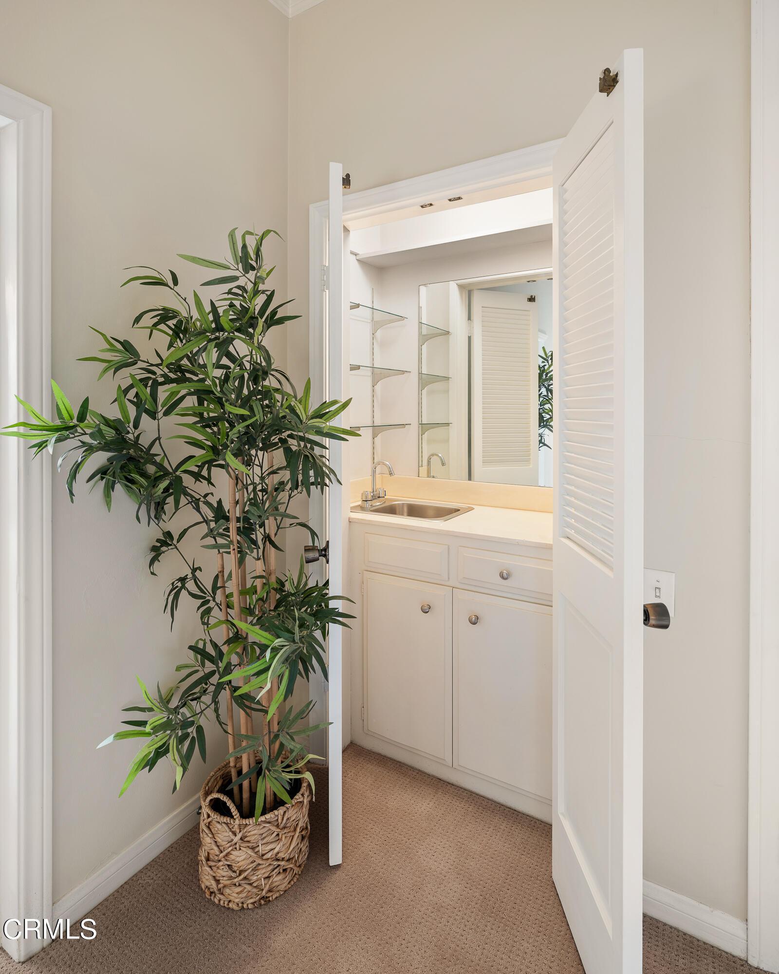 307 Arlington Drive Pasadena, CA 91105 - Photo 20 of 50 a bathroom with a sink a mirror and a potted plant