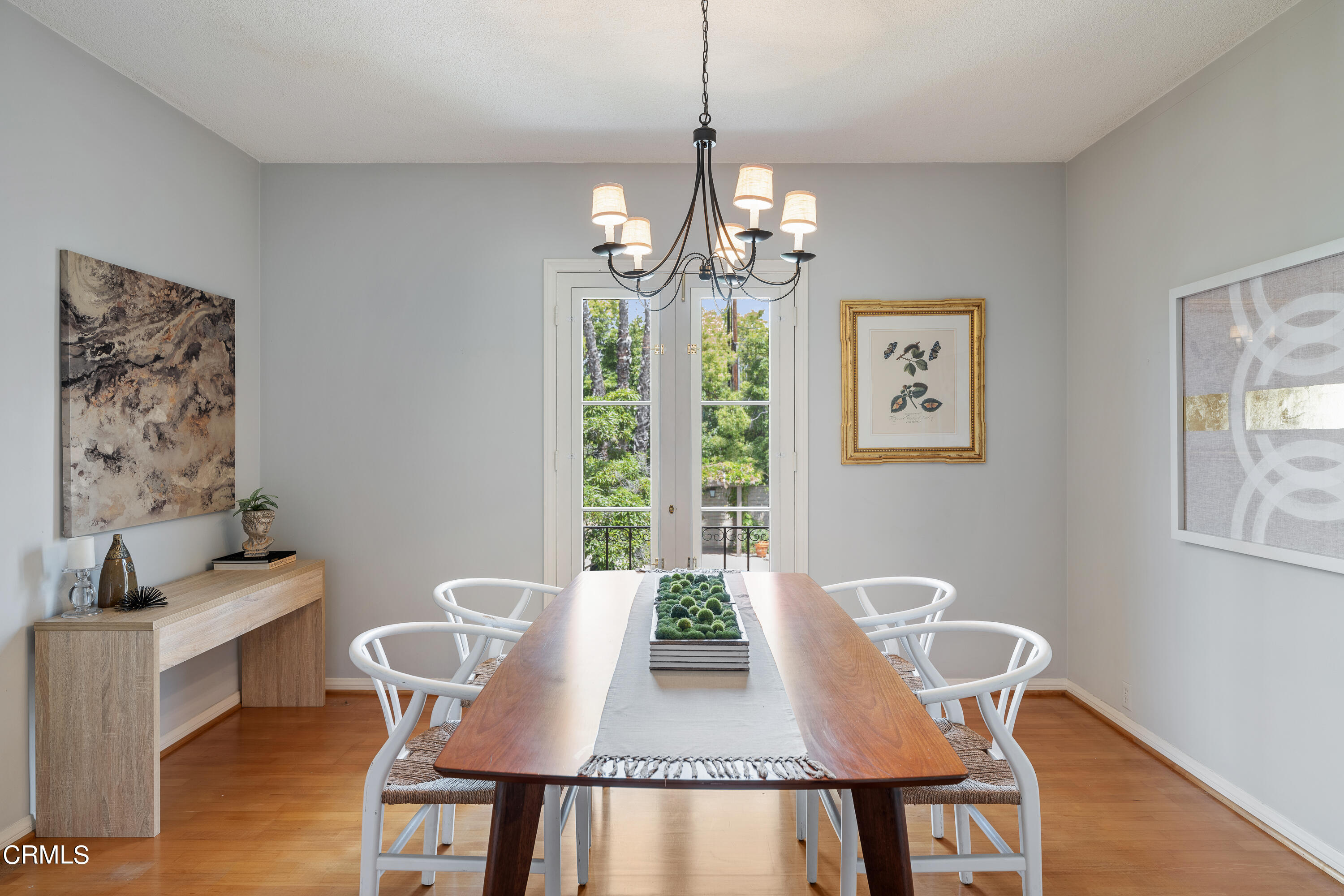307 Arlington Drive Pasadena, CA 91105 - Photo 22 of 50 a view of a dining room with furniture a chandelier and wooden floor