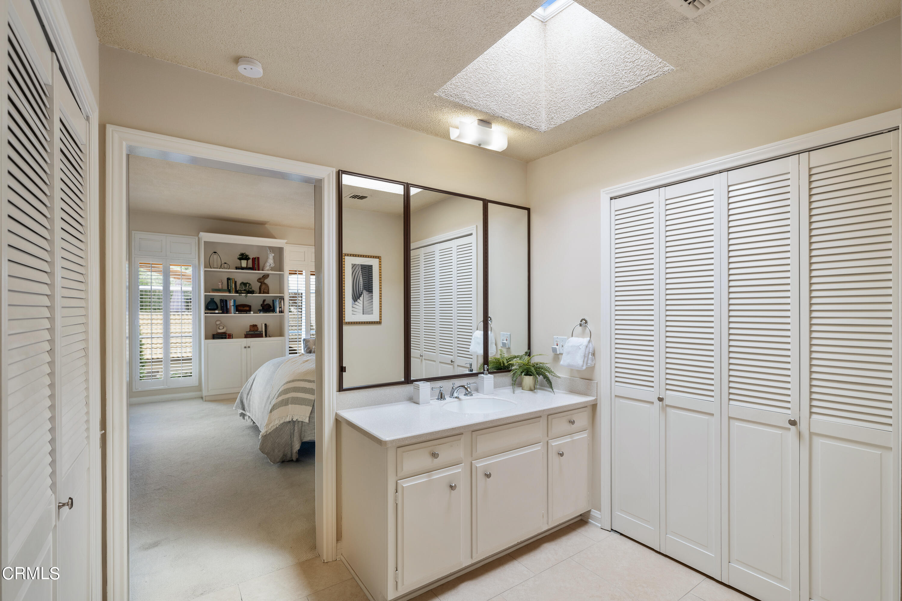 307 Arlington Drive Pasadena, CA 91105 - Photo 39 of 50 a bathroom with a double vanity sink and mirror