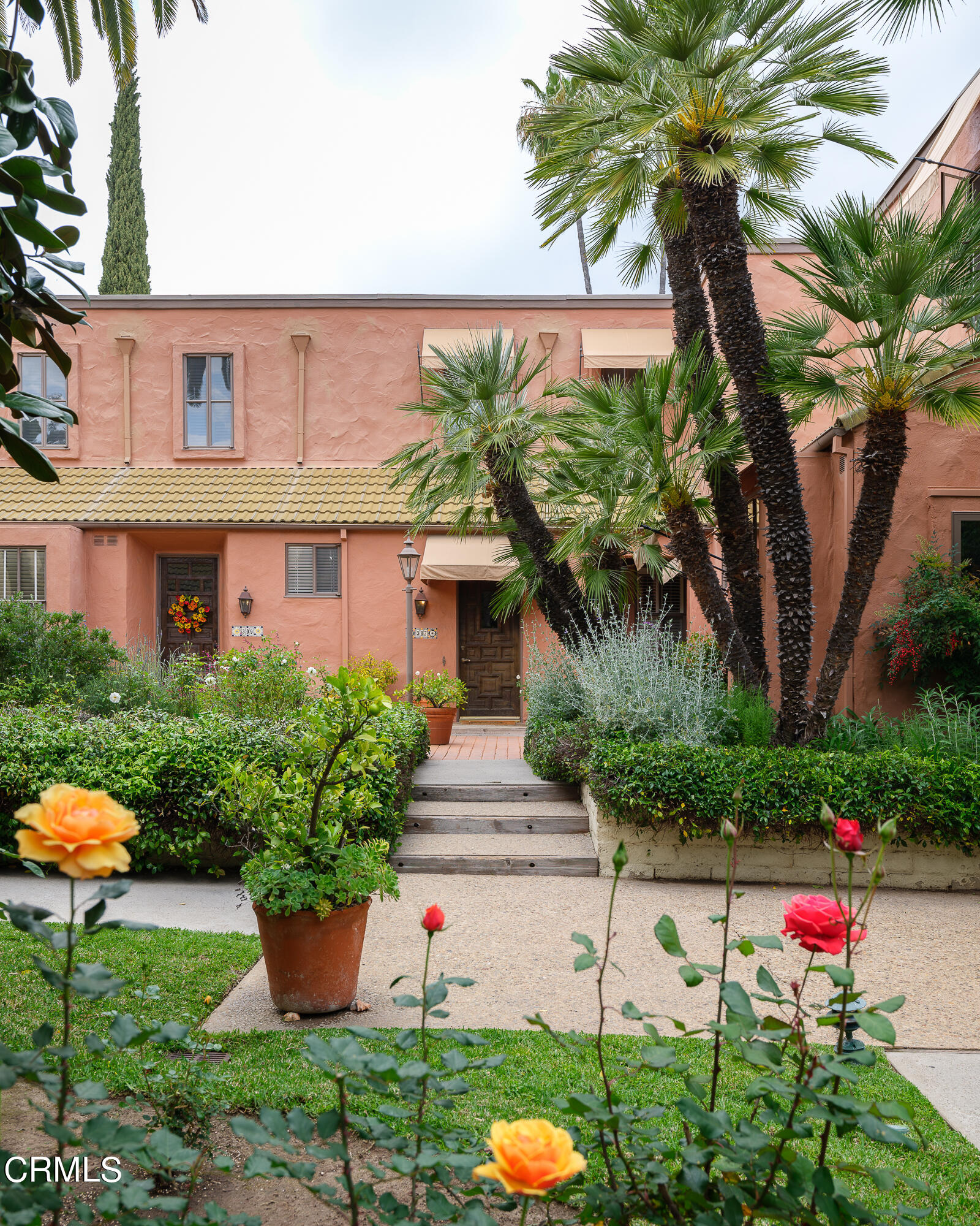 307 Arlington Drive Pasadena, CA 91105 - Photo 4 of 50 a front view of a house with a yard and fountain
