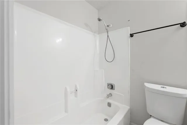 a bathroom with a bath tub with a shower