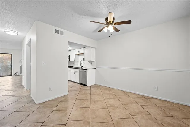 a view of a kitchen with wooden cabinet and a refrigerator