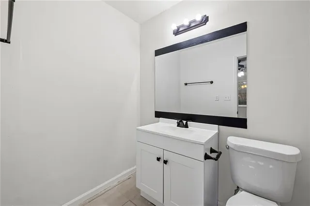 a bathroom with a sink a toilet and mirror