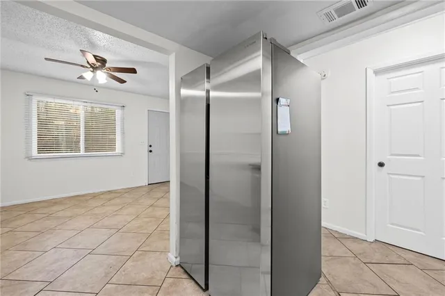 a view of an empty room with a fan