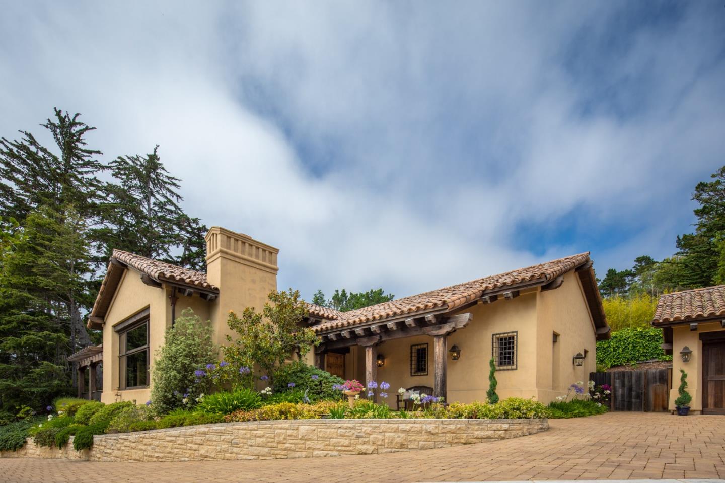 1425 Oleada Road Pebble Beach, CA 93953 - Photo 19 of 26 a front view of a house with a garden