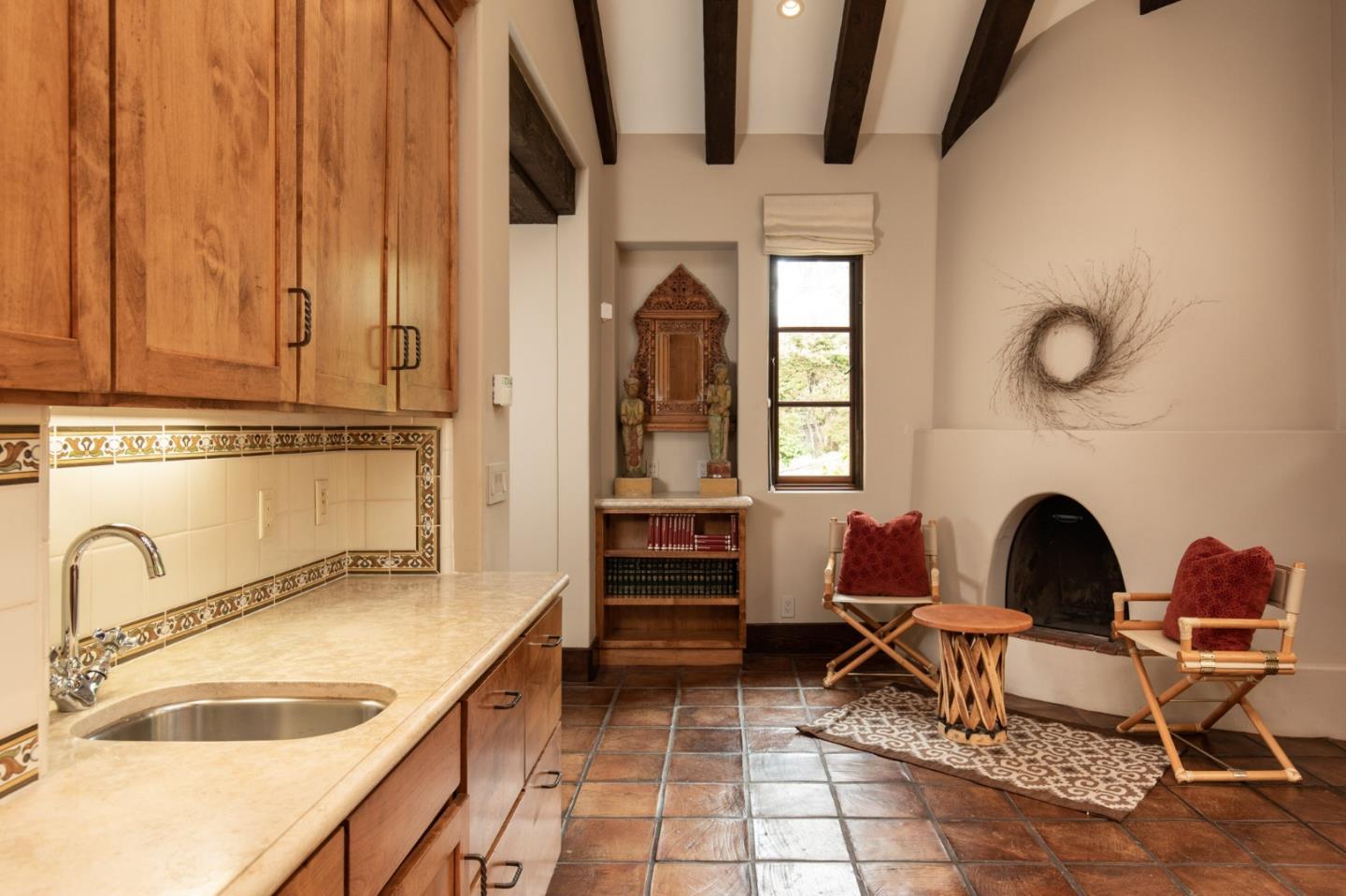 1425 Oleada Road Pebble Beach, CA 93953 - Photo 6 of 26 a dining room with furniture and a fireplace