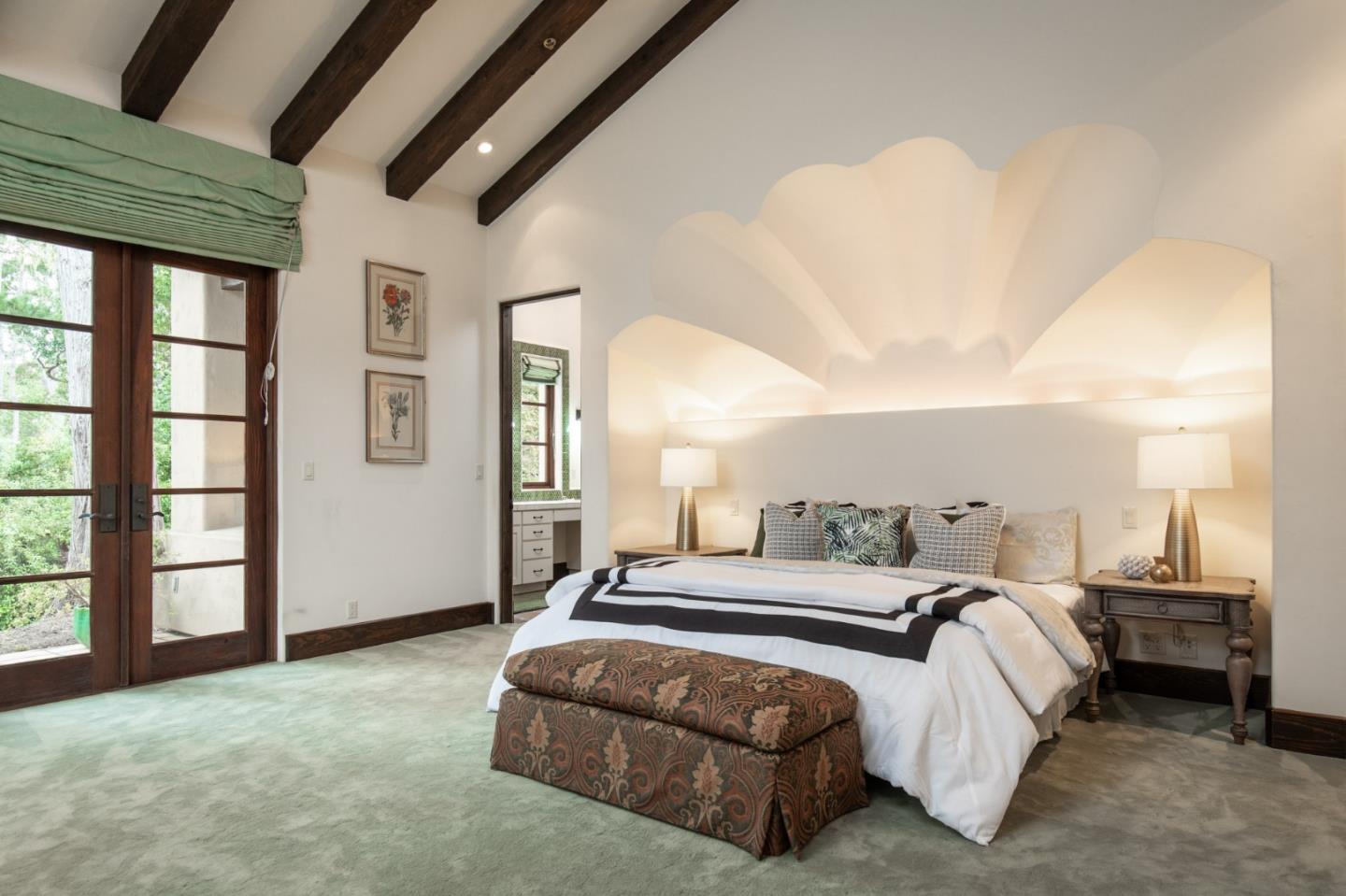 1425 Oleada Road Pebble Beach, CA 93953 - Photo 10 of 26 a spacious bedroom with a bed a table and large window