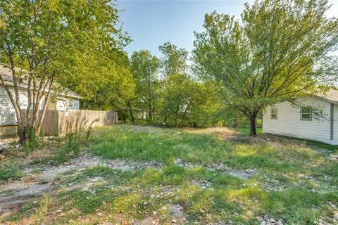 a view of backyard with large trees