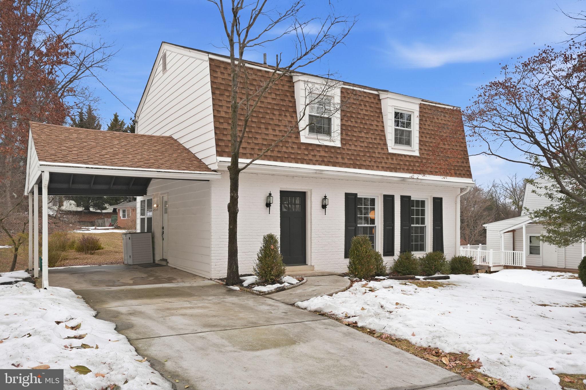 a view of a house with snow on the side of the road