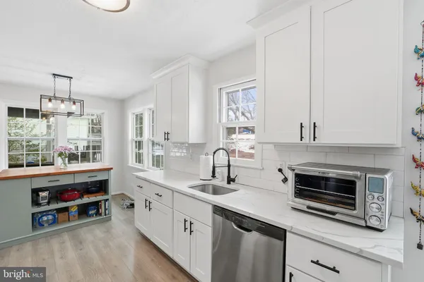 a kitchen with stainless steel appliances a stove sink and cabinets