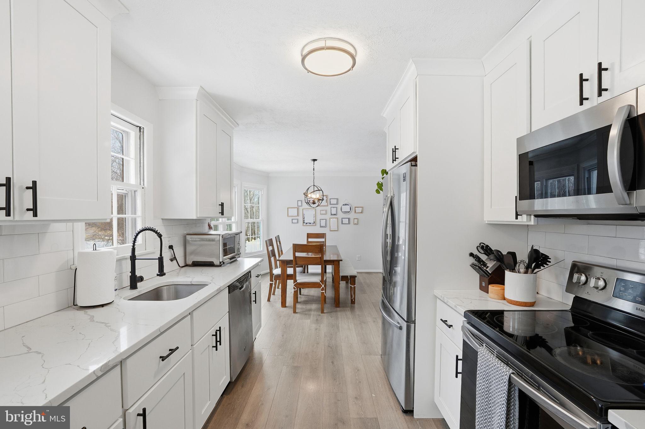 2207 Victor Court Silver Spring, MD 20906 - Photo 13 of 40 a kitchen with sink a stove and cabinets