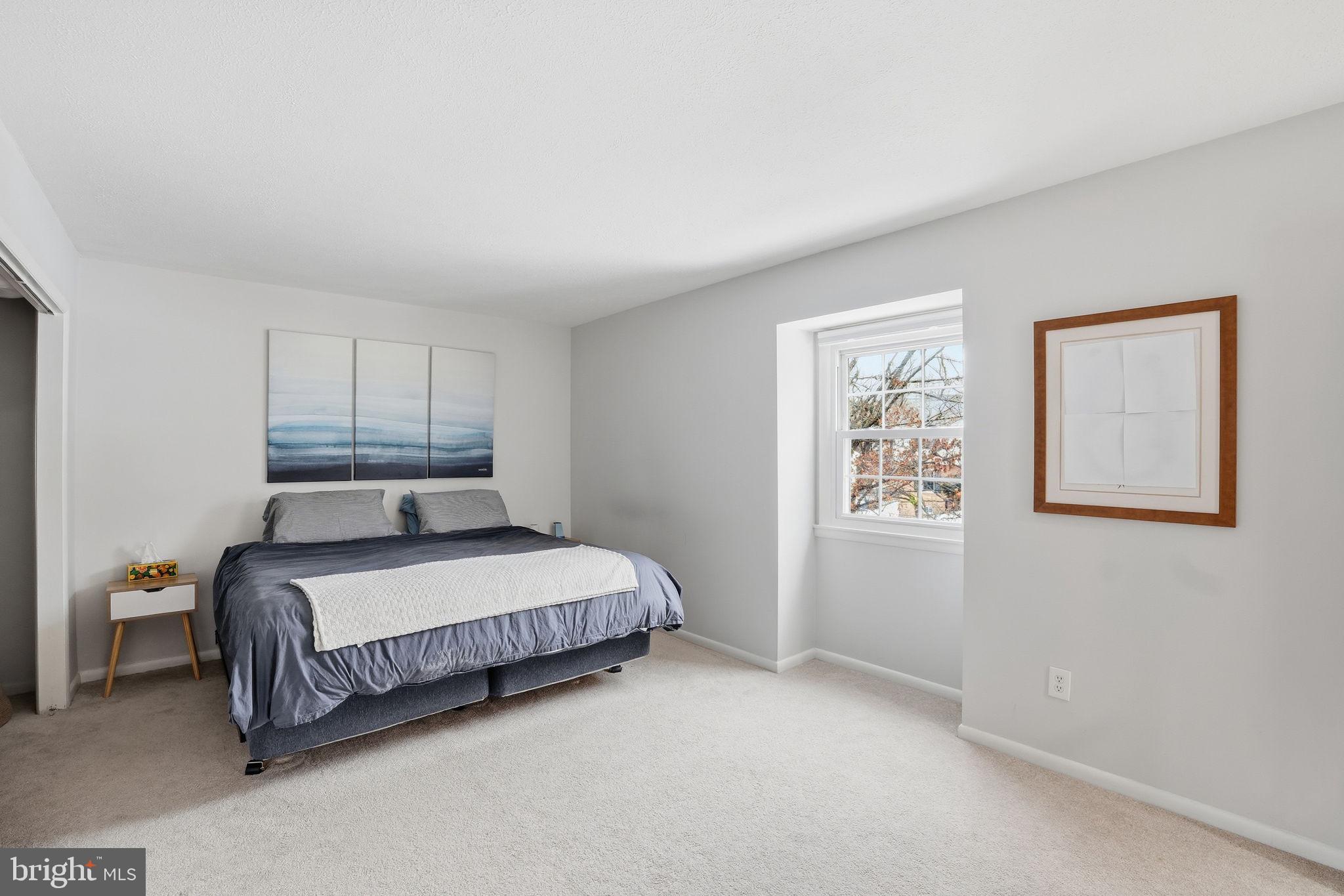 2207 Victor Court Silver Spring, MD 20906 - Photo 16 of 40 a spacious bedroom with a bed and a window