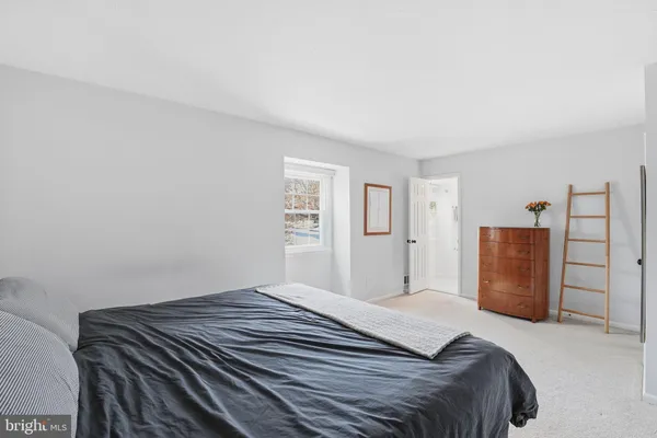 a bedroom with a bed and a closet