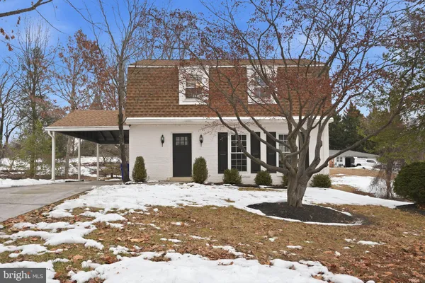 a view of a white house with a yard