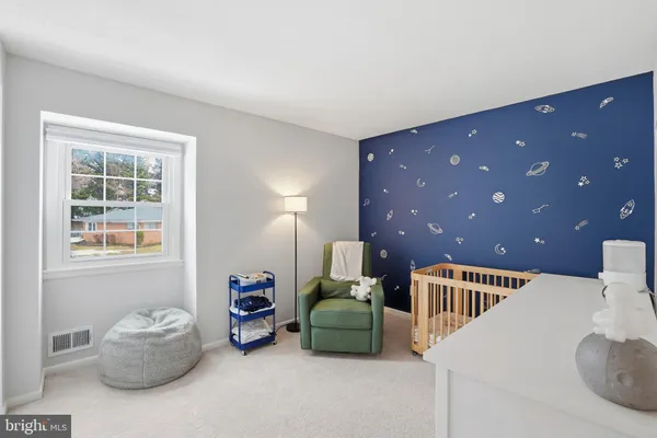 a hallway with a dresser and a couch