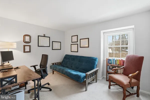 a workspace with furniture and white walls