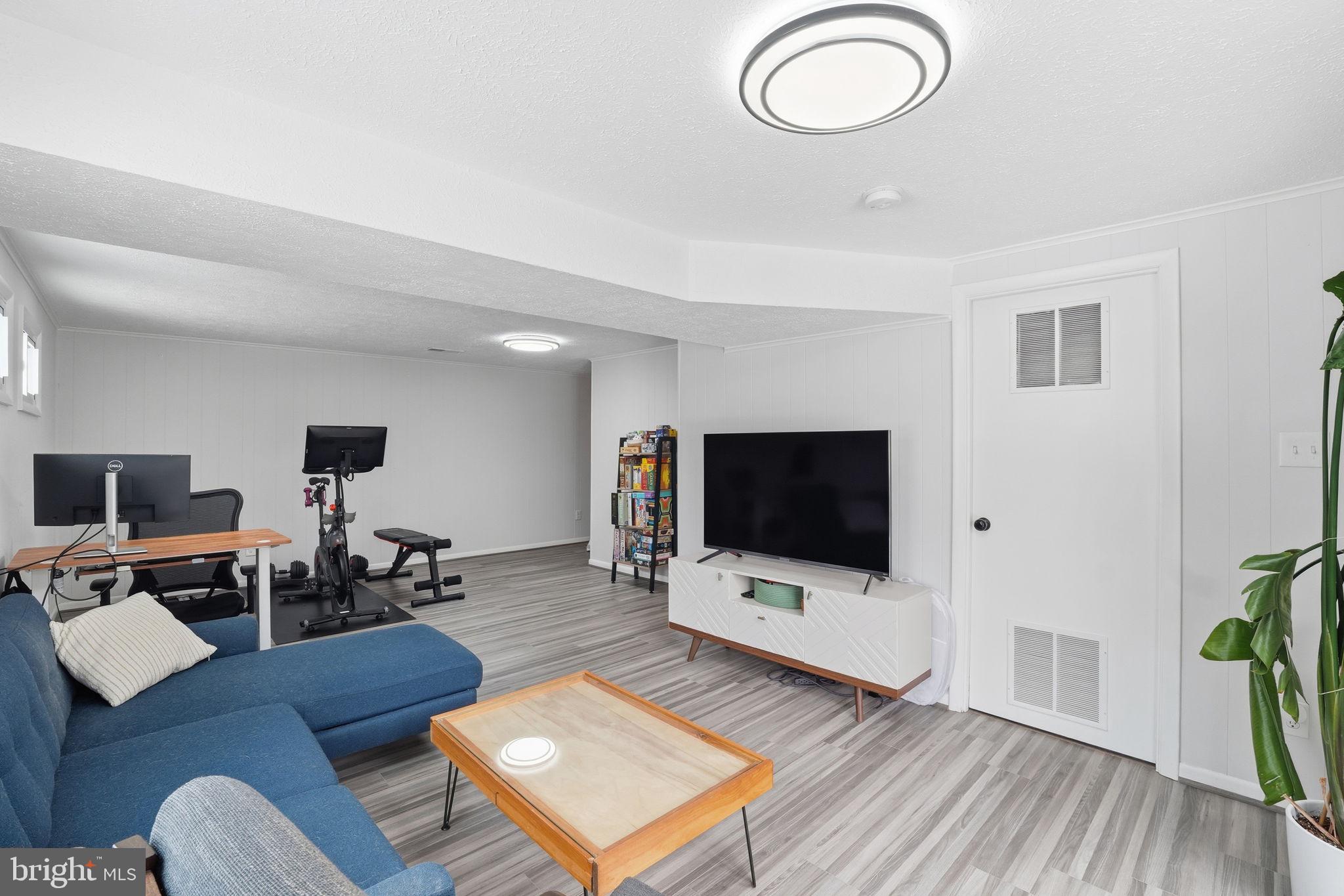 2207 Victor Court Silver Spring, MD 20906 - Photo 28 of 40 a living room with furniture and a flat screen tv