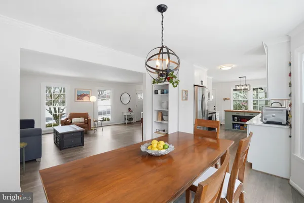 a living room with furniture and chandelier