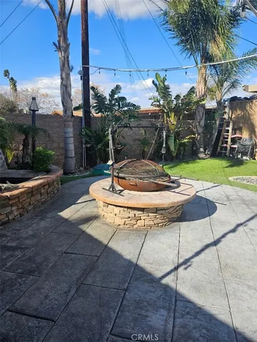 a view of a backyard with plants and patio