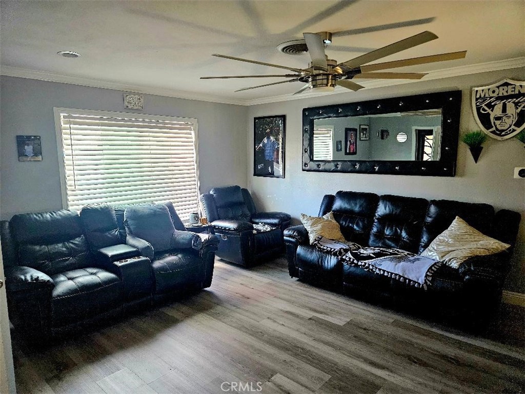 19263 Easton Street Rialto, CA 92376 - Photo 3 of 16 a living room with furniture and a flat screen tv