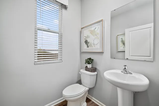 a bathroom with a sink mirror and toilet