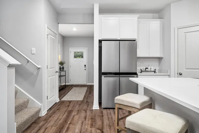 a kitchen with white cabinets and stainless steel appliances