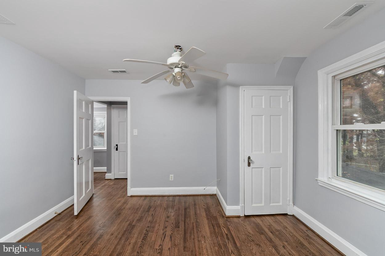 650 Aldershot Road Baltimore, MD 21229 - Photo 22 of 36 wooden floor in an empty room with a window