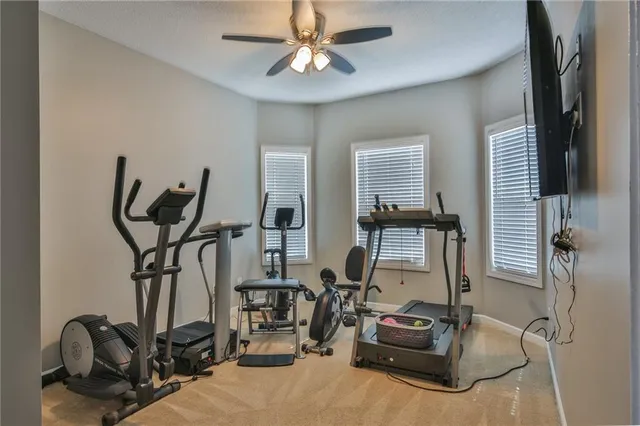 a room with gym equipment and windows