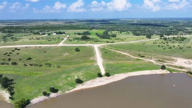 a view of a field with an ocean view