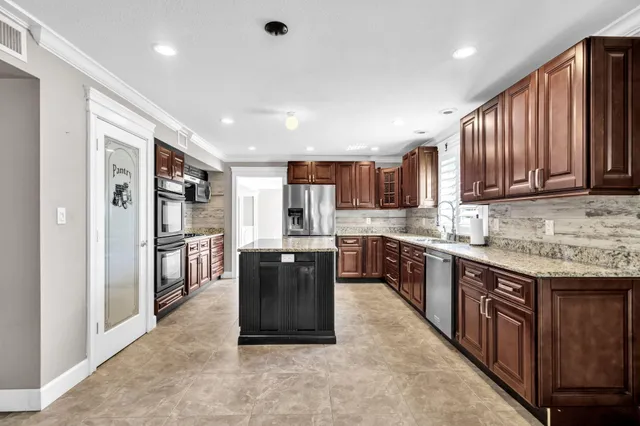 a view of a kitchen with a sink and a window