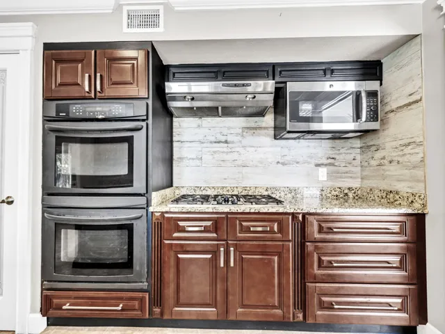 a bedroom with a bed and a night stand