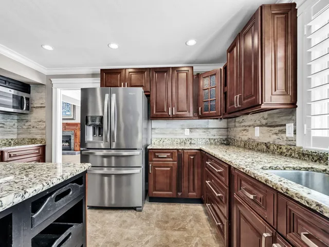 a view of a big room with chandelier and windows