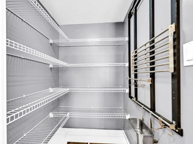 a view of a patio with table and chairs potted plants with wooden floor and fence