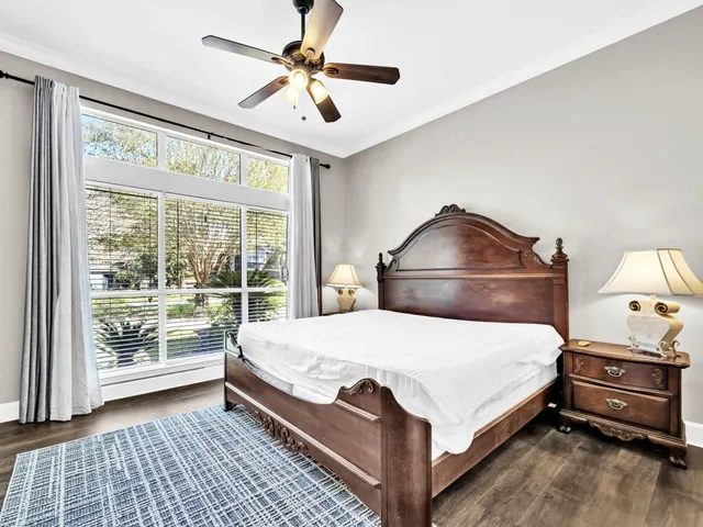a patio with table and chairs and potted plants