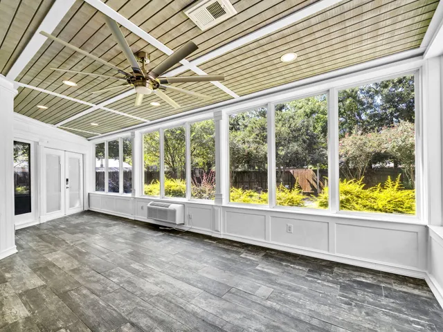 an aerial view of residential houses with outdoor space and trees