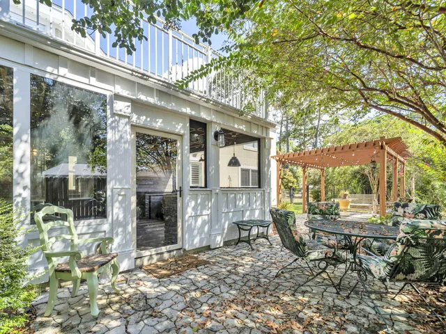 an aerial view of residential house with outdoor space and trees all around