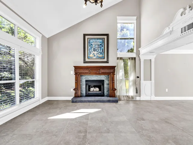 a view of an entryway with floor to ceiling windows and a chandelier