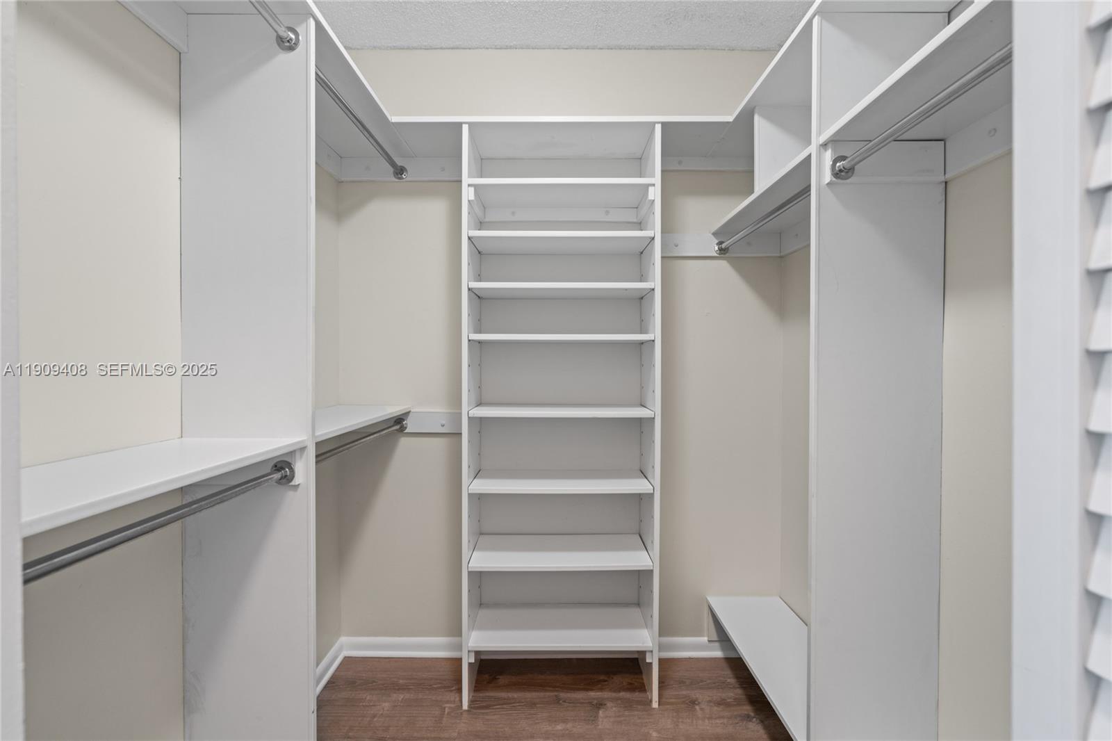 4101 Pine Tree Drive, Unit 802 Miami Beach, FL 33140 - Photo 16 of 58 a view of walk in closet with empty racks