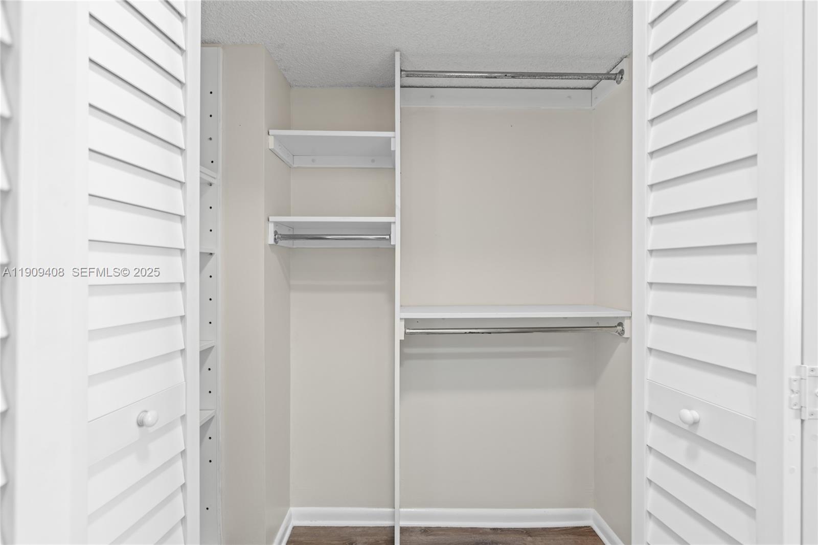 4101 Pine Tree Drive, Unit 802 Miami Beach, FL 33140 - Photo 17 of 58 a view of walk in closet with empty racks