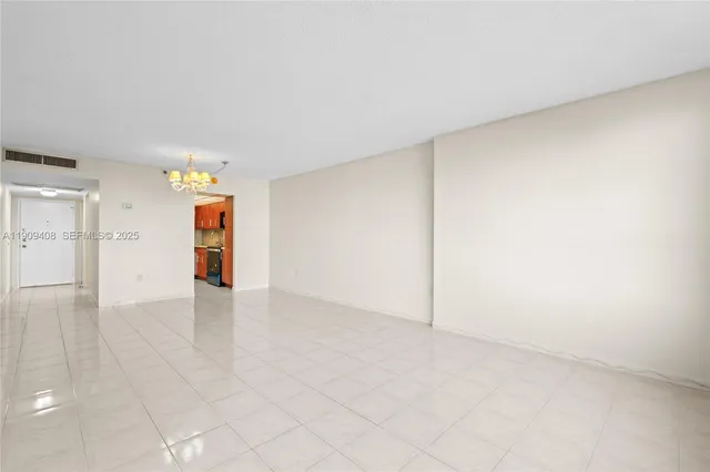 a kitchen with stainless steel appliances granite countertop a refrigerator a stove and a sink