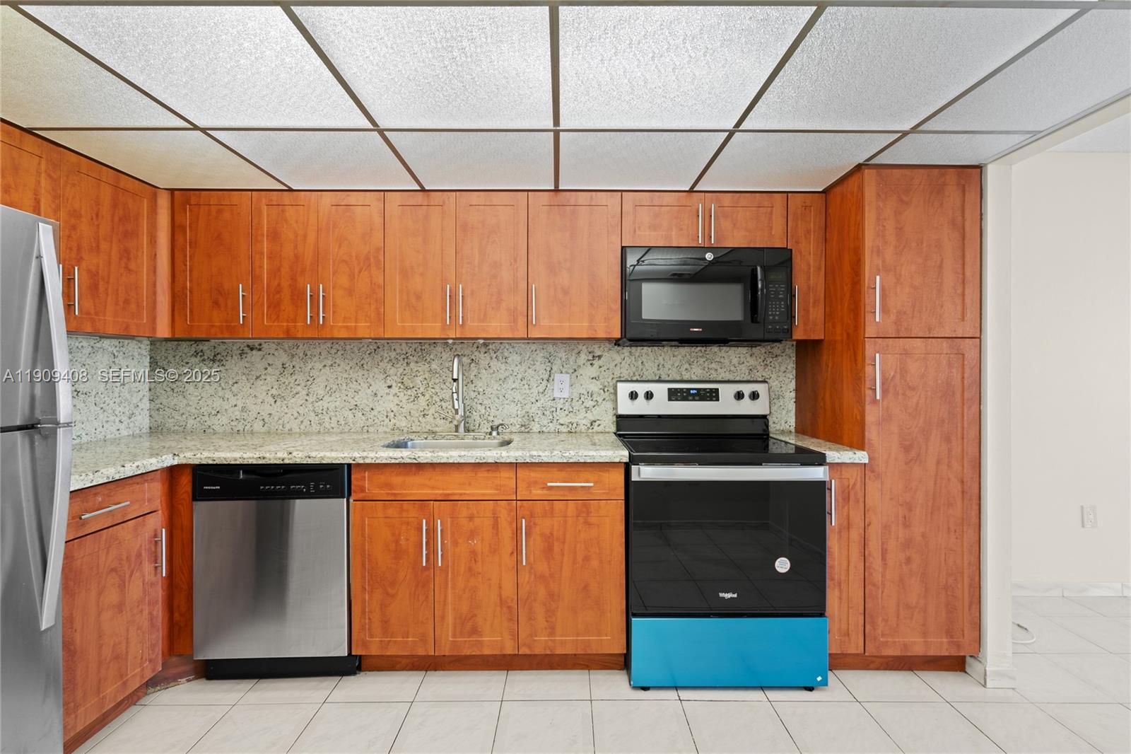 4101 Pine Tree Drive, Unit 802 Miami Beach, FL 33140 - Photo 8 of 58 a kitchen with a stove and a microwave